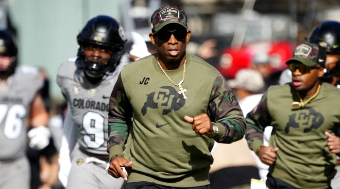 Colorado Buffaloes head coach Deion Sanders runs on to the field before a game against Arizona.
